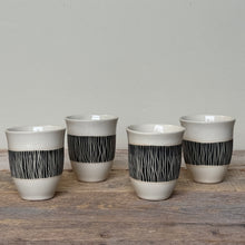 Load image into Gallery viewer, Four ceramic cups with black patterned bands on a wooden surface