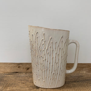 MILK JUG IN OATMEAL WITH PUSSY WILLOWS